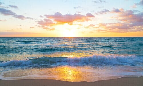 Beautiful photo of a sunrise over the ocean waves and shoreline in Florida