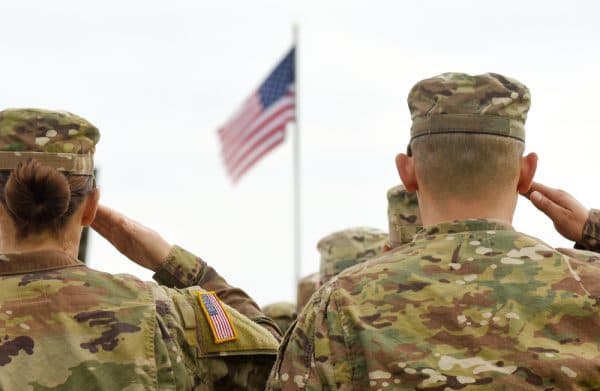 Female and Male soldier saluting the American flag