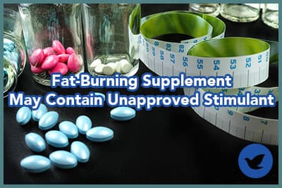 Fat burning and weight loss - food suppliment centimetre on black background copy space