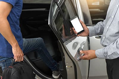 traveler or tourists go in to the car driver use smart phone from taxi car sharing with white mobile phone screen