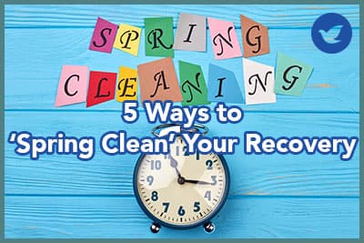 Time for clean up for spring. Blue alarm clock and colorful letters spring cleaning.