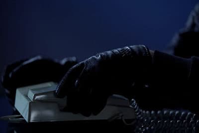 Unidentified man puts handset down after calling