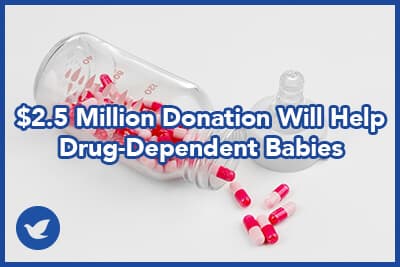 Feeding bottle with pills on white background